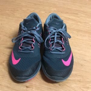 Pink and grey Nike running shoes.